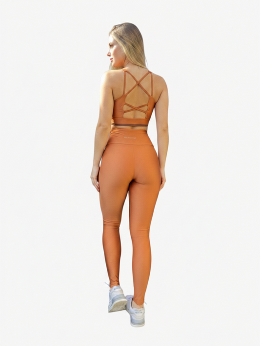 JM Brazilian Activewear copper cross-back sports bra and high-waisted leggings set worn by a woman from behind
