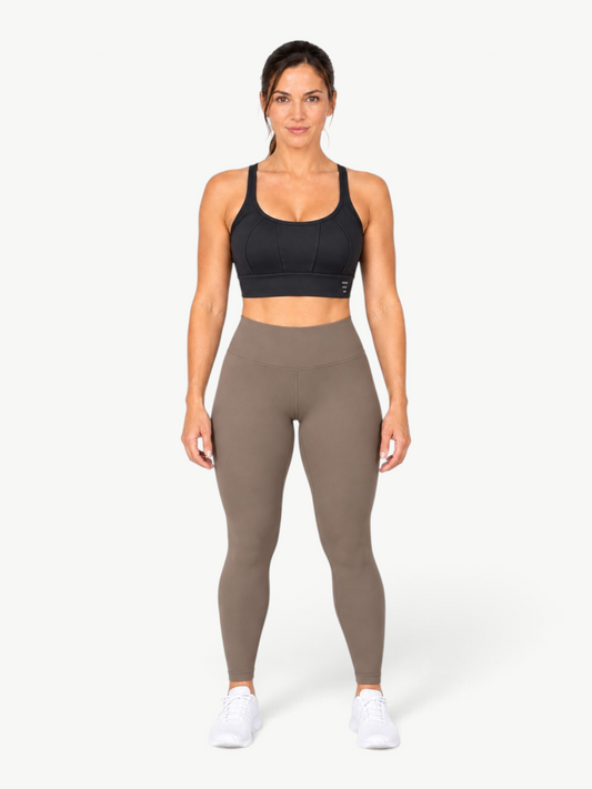 JM Brazilian Activewear Flow Sculpt Top in black with scoop neckline, wide straps, and contour seams on a model.