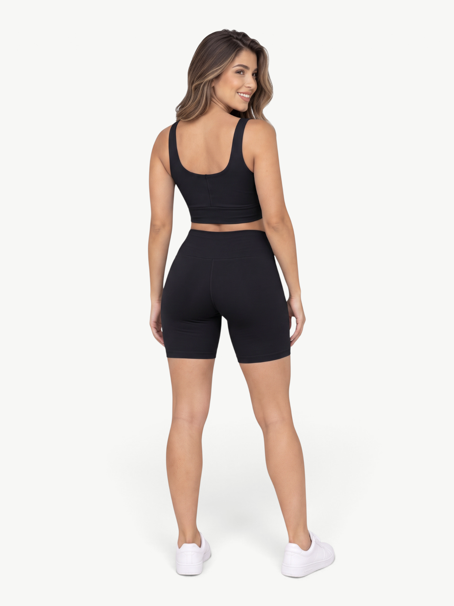 Model wearing JM Brazilian Activewear black Sculpt Biker Short Set with cropped tank and high-waisted shorts, back view