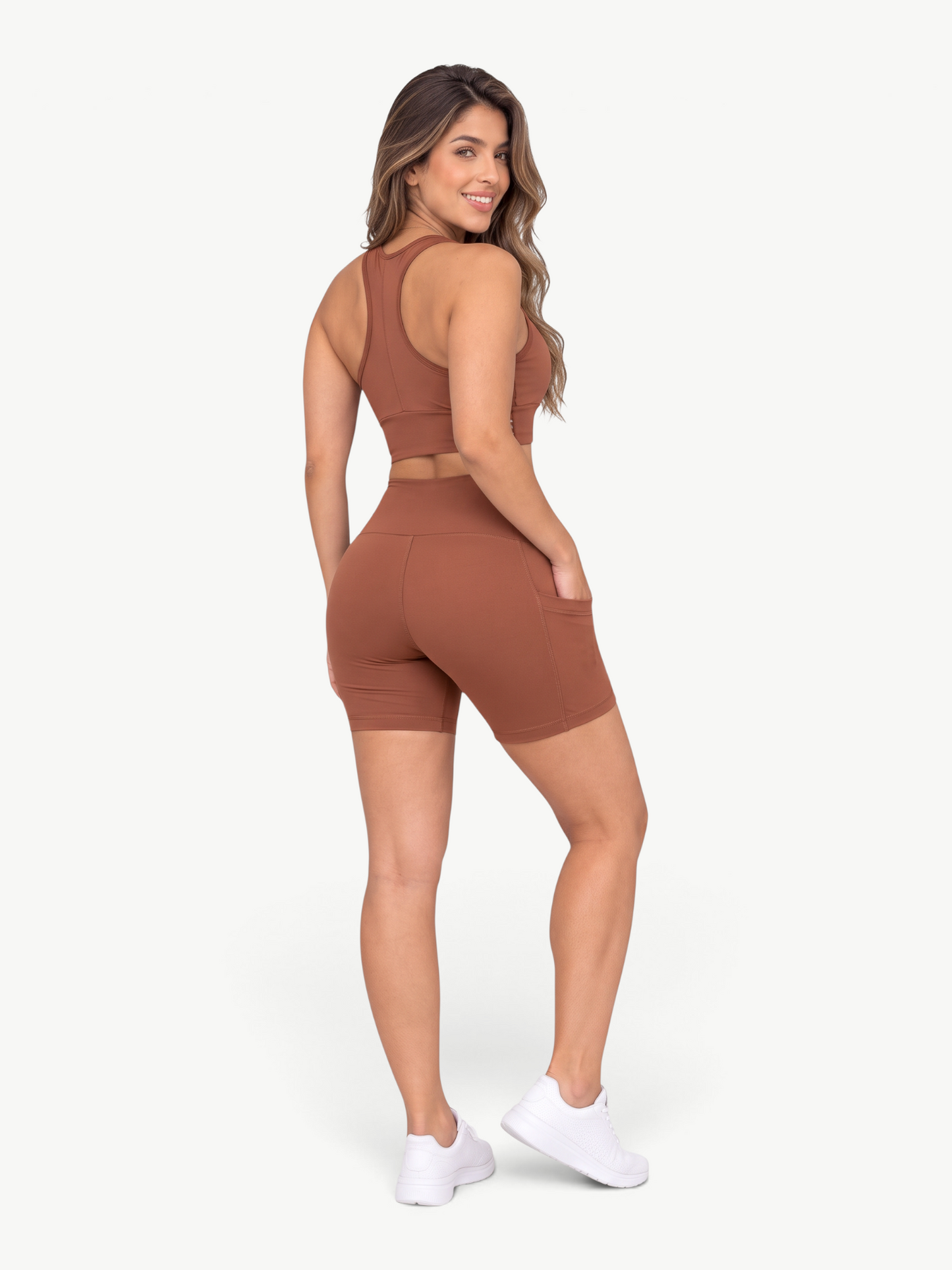 JM Brazilian Activewear brown high-waisted biker shorts with side pockets worn by a woman, back view.