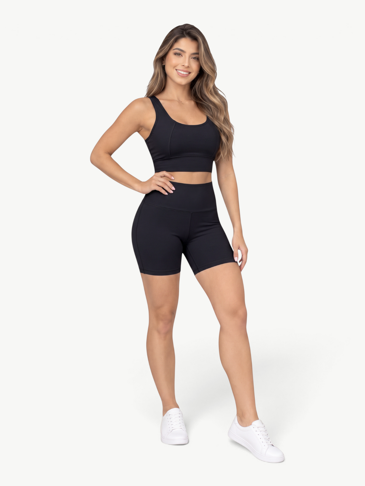Model wearing a black JM Brazilian Activewear Sculpt Biker Short Set with a scoop neck tank and high-waisted shorts.