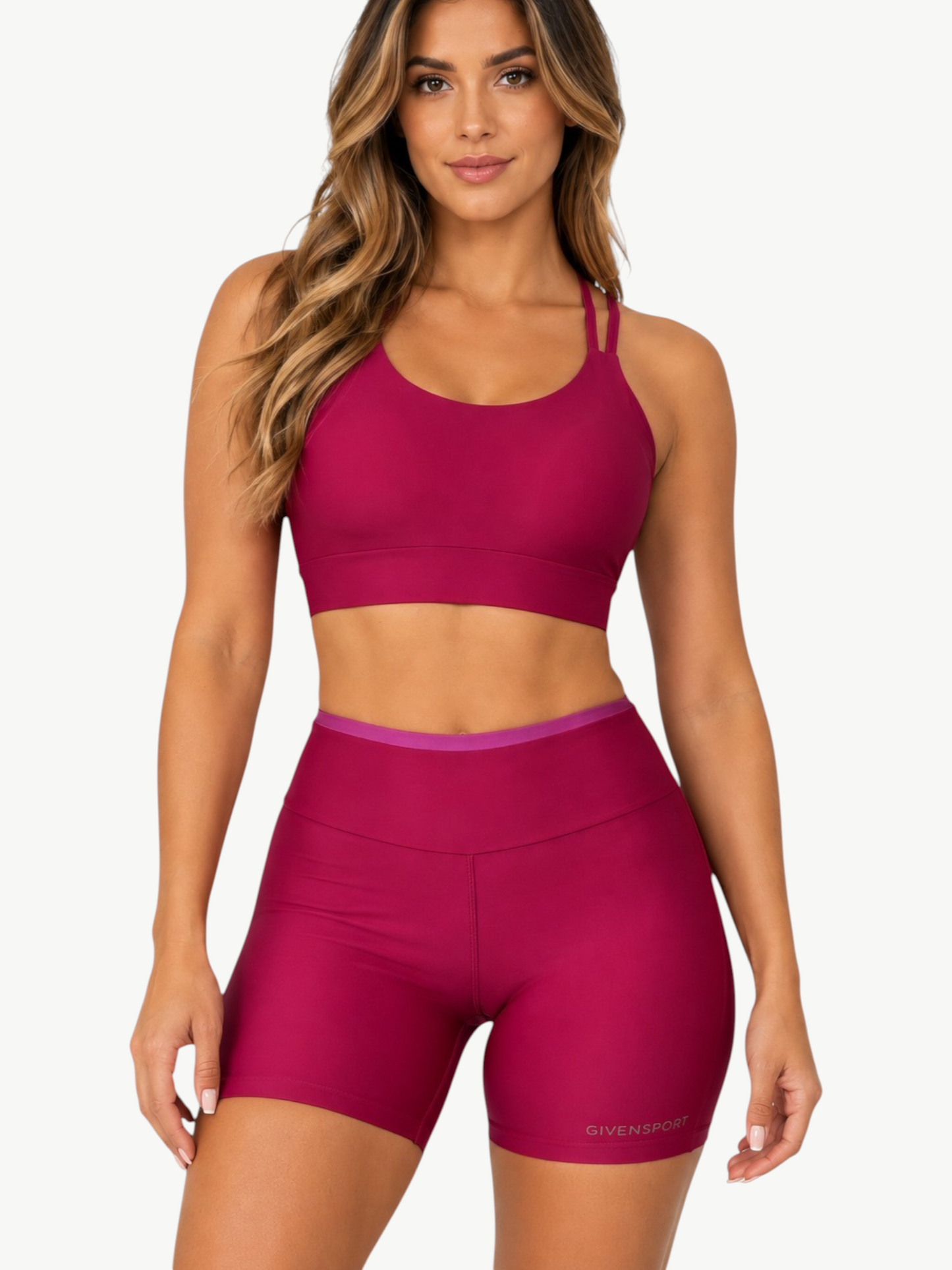 Model wearing JM Brazilian Activewear Aurora deep pink matching set with supportive crop top and high-waisted shorts.