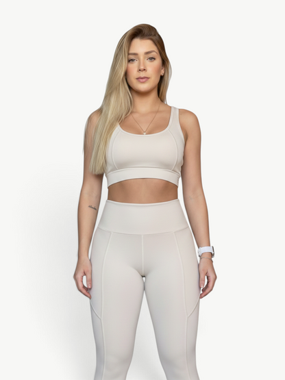 Model wearing JM Brazilian Activewear Polianna beige high-waisted legging set with a supportive crop top