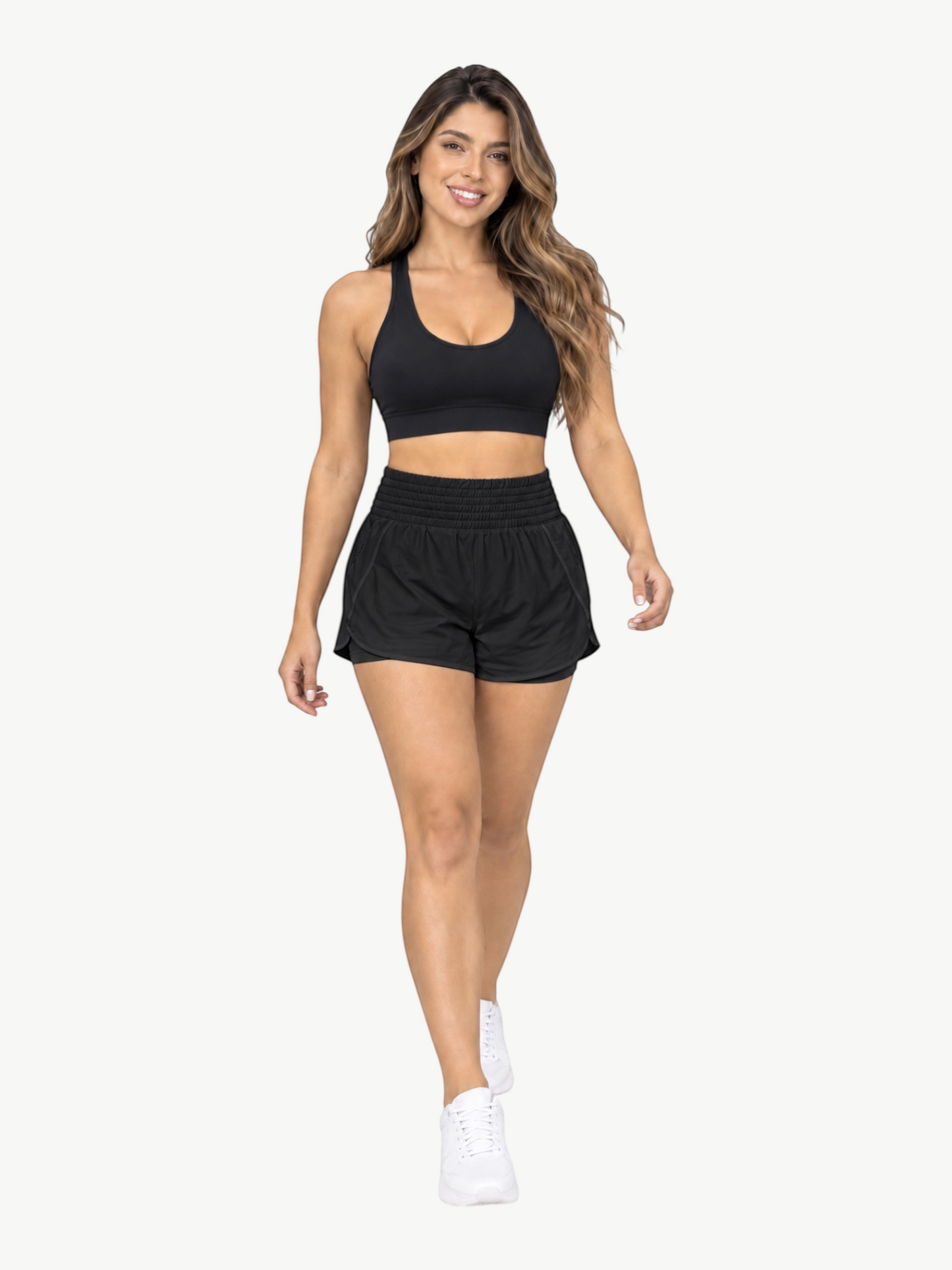 Model wearing JM Brazilian Activewear black 2-in-1 athletic shorts with a high waistband and matching sports bra