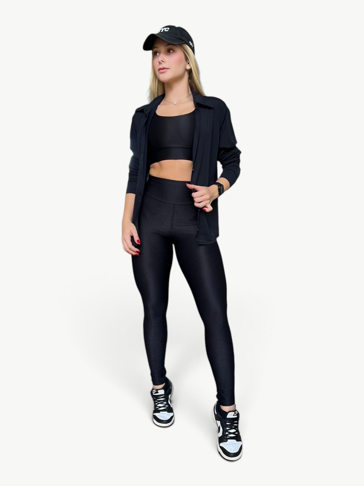 JM Brazilian Activewear long sleeve black button-up top worn over a matching sports bra and leggings by a blonde model
