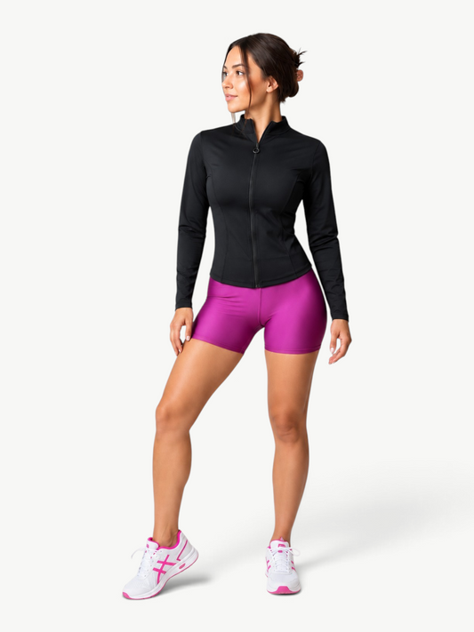 Woman wearing a JM Brazilian Activewear black lightweight zip-up jacket with magenta athletic shorts