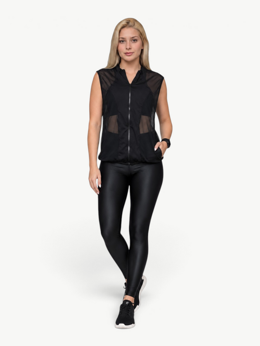 JM Brazilian Activewear black mesh vest with front zipper worn by a blonde model over matching black leggings.