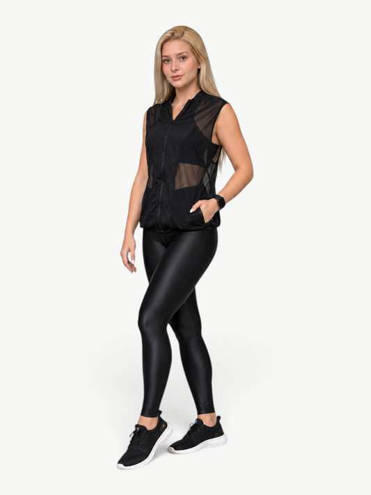 Model wearing a black JM Brazilian Activewear Dark Flow Mesh Vest with a front zipper and breathable mesh panels.