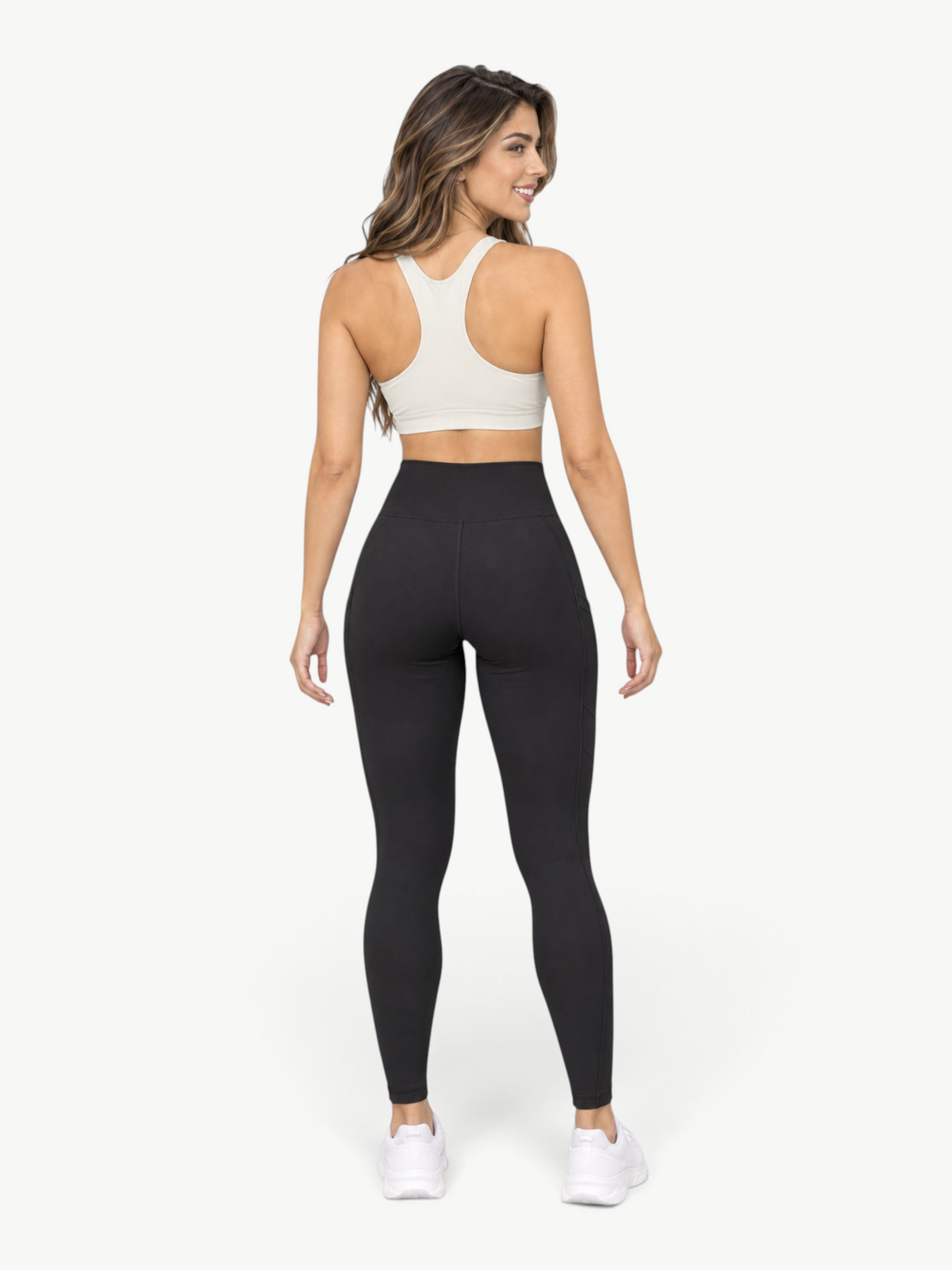 JM Brazilian Activewear black high-rise leggings with side pockets worn by a woman from the back view