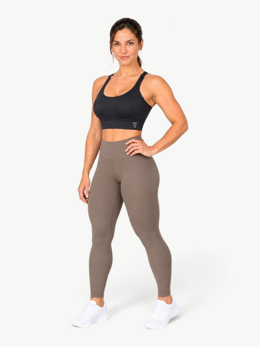 JM Brazilian Activewear black Flow Sculpt Top with scoop neckline and contour seams worn by a model.