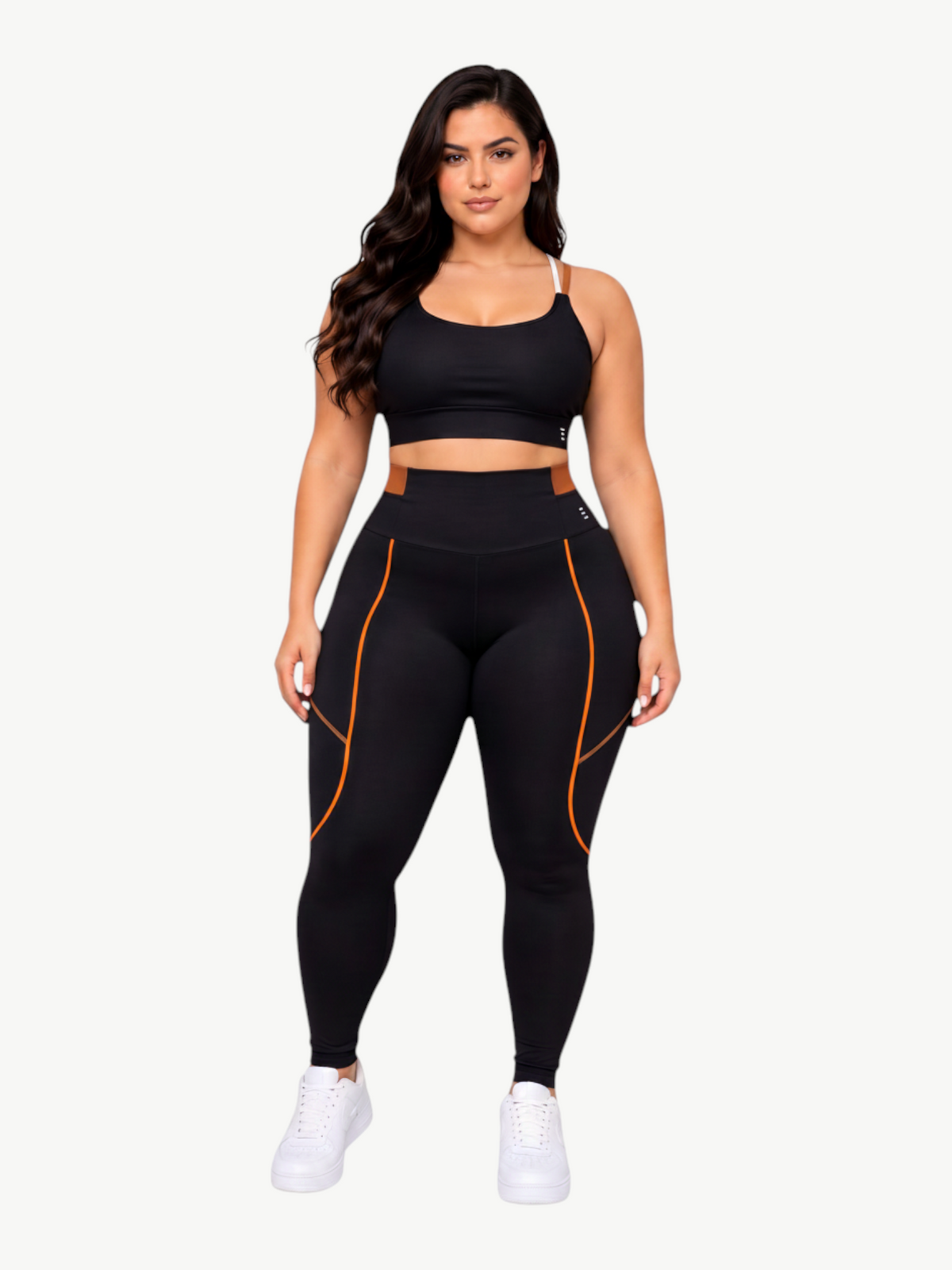 Model wearing JM Brazilian Activewear black sculpting legging set with orange trim and supportive sports bra