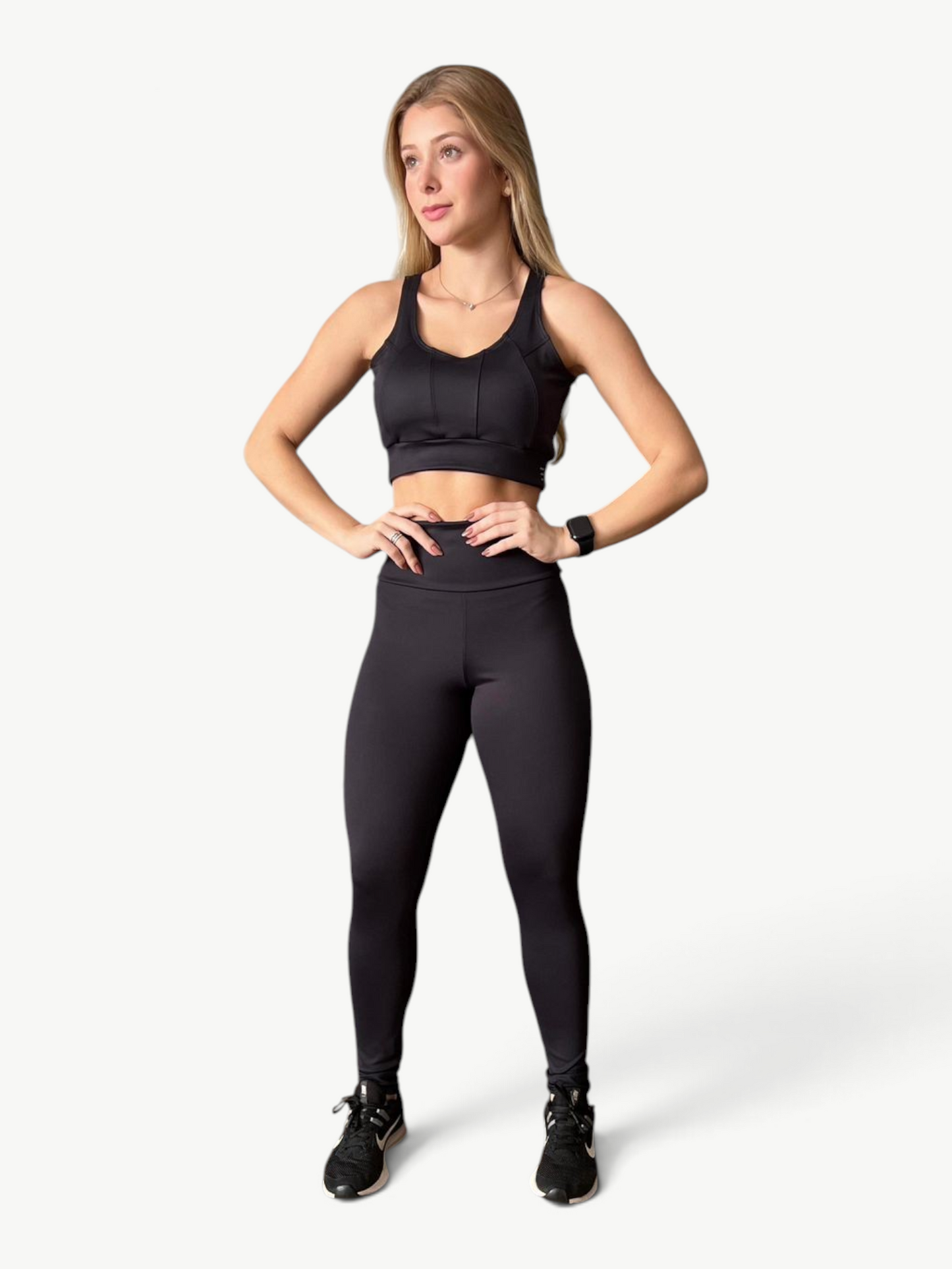 Model wearing JM Brazilian Activewear black high-waisted sculpting leggings and matching sports bra