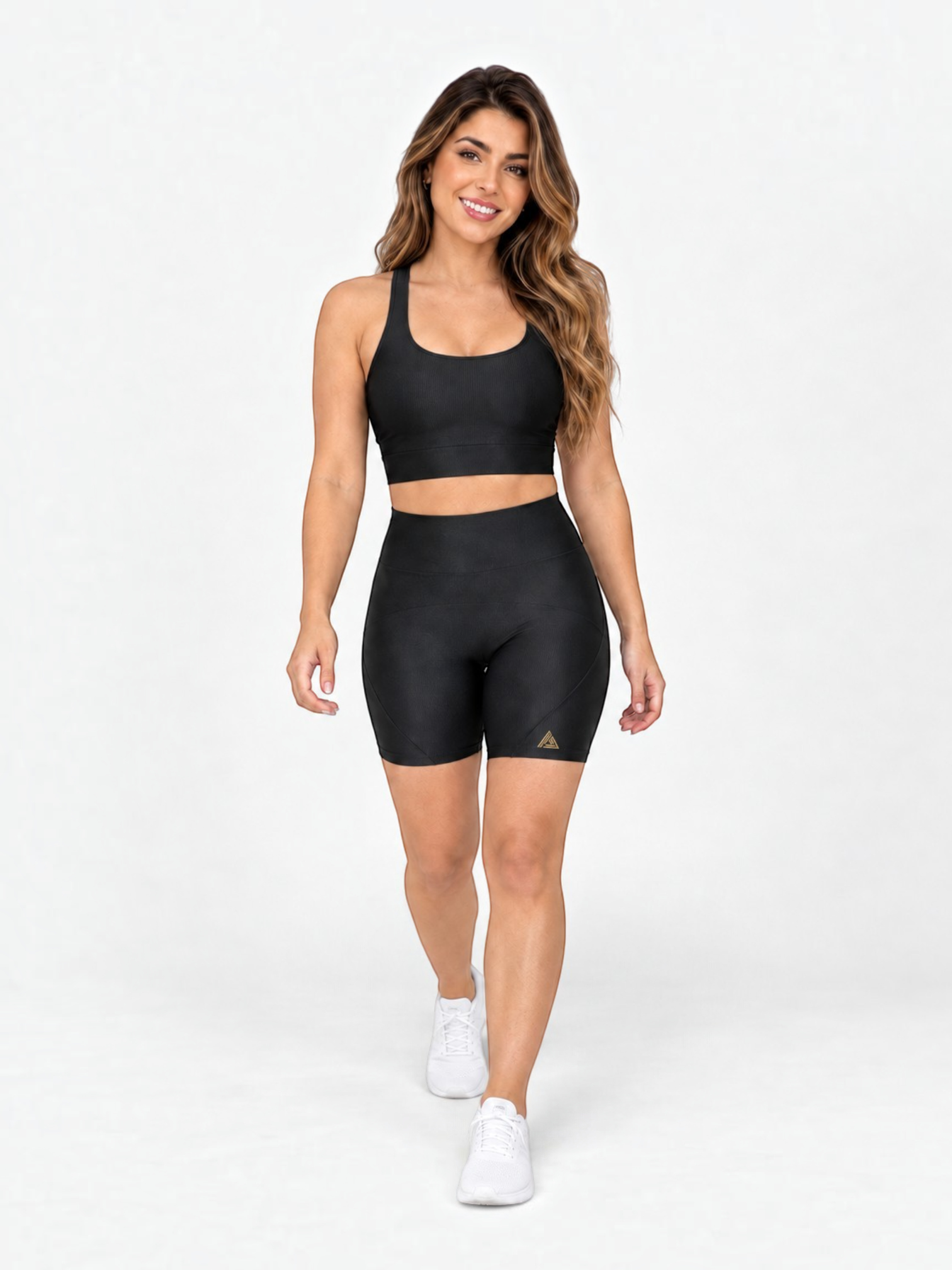 JM Brazilian Activewear black two-piece set with a supportive crop top and high-waisted biker shorts on a model