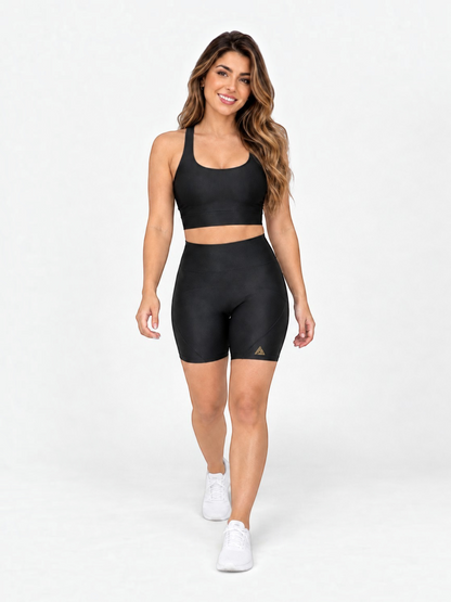 JM Brazilian Activewear black two-piece set with a supportive crop top and high-waisted biker shorts on a model