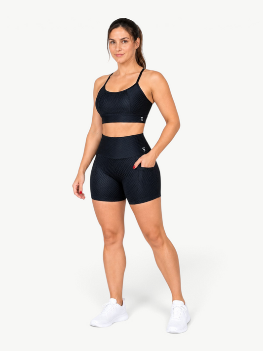 JM Brazilian Activewear black textured two-piece workout set with high-waisted shorts and a functional side pocket.