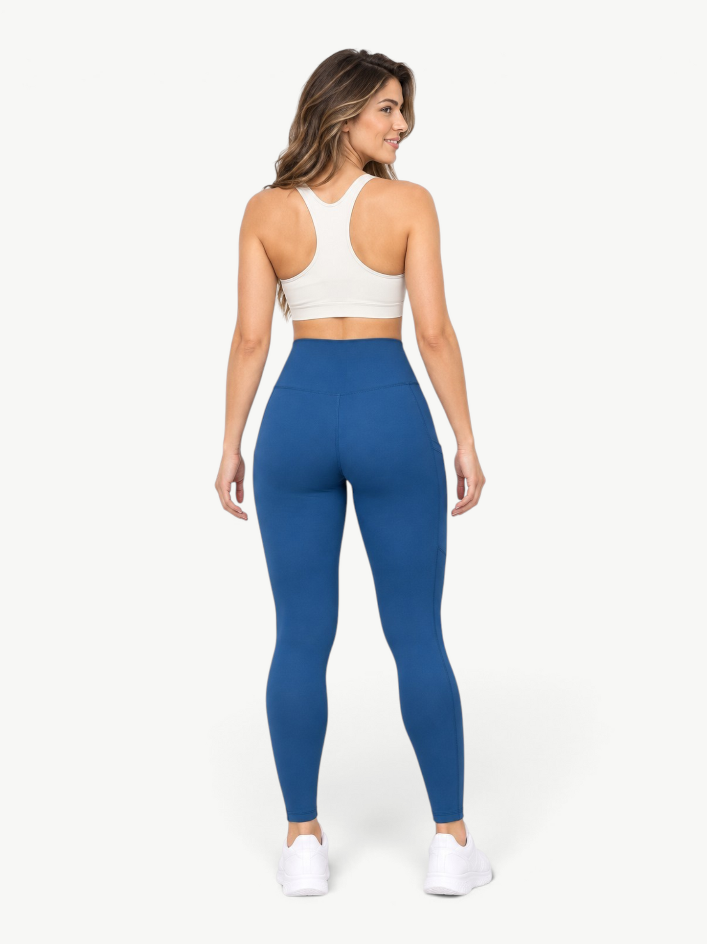 JM Brazilian Activewear blue high-rise leggings with side pockets on a model, back view, bleach-resistant fabric.