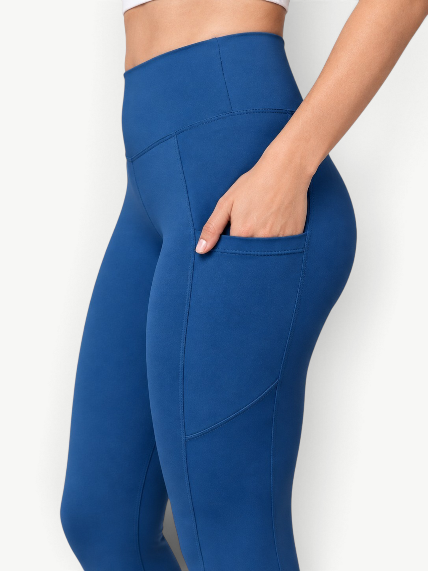 JM Brazilian Activewear high-rise blue leggings with functional side pockets, made from smooth, bleach-resistant fabric.