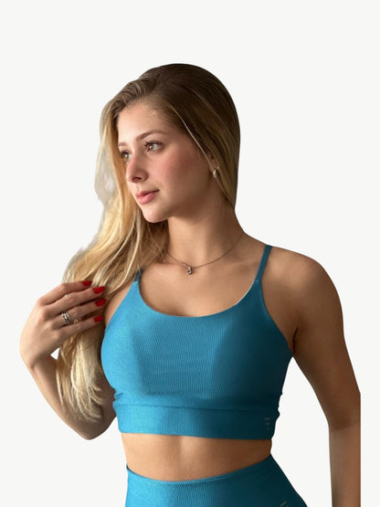 JM Brazilian Activewear blue ribbed sports bra and high-waisted leggings set worn by a blonde woman