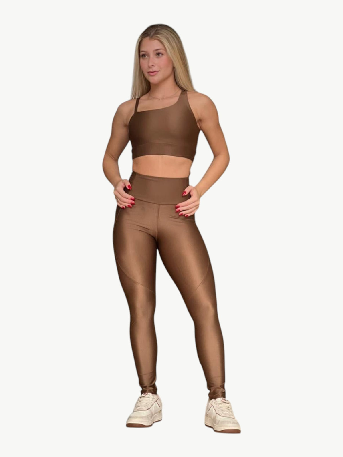 Model wearing a bronze JM Brazilian Activewear sculpting crossback top and high-waisted leggings set.