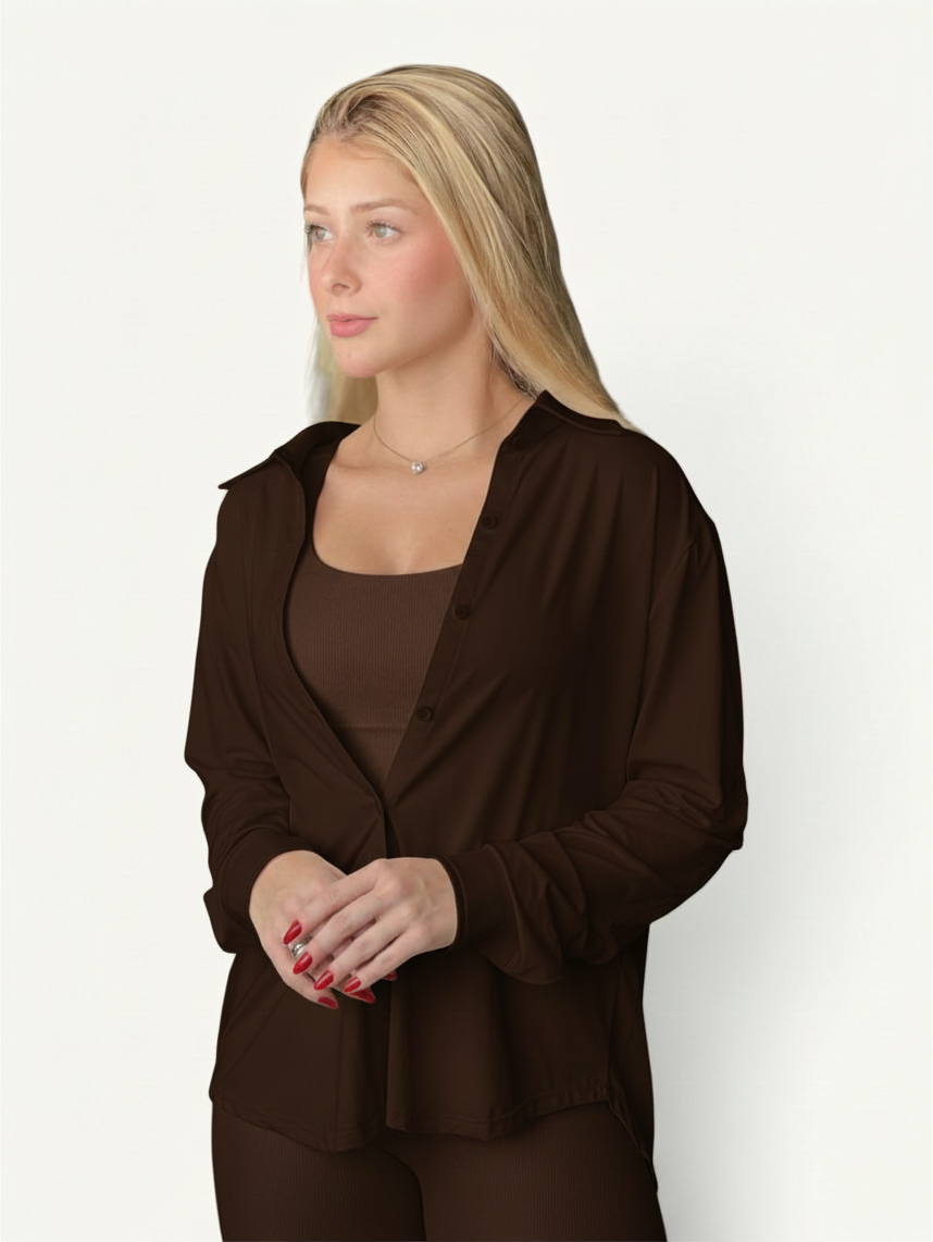 Blonde model wearing a dark brown JM Brazilian Activewear long sleeve button-up top over a matching ribbed tank top.