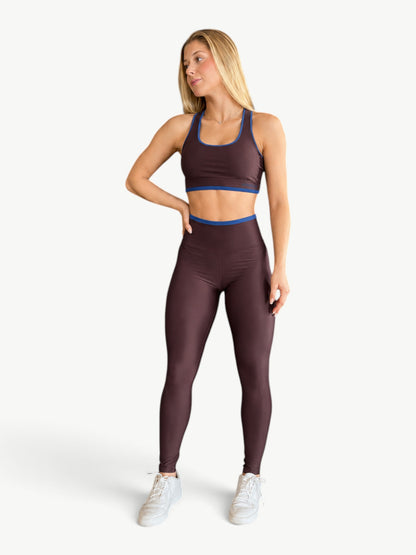 Model wearing JM Brazilian Activewear Speed Contrast Legging Set in dark brown with blue trim and high-rise fit.
