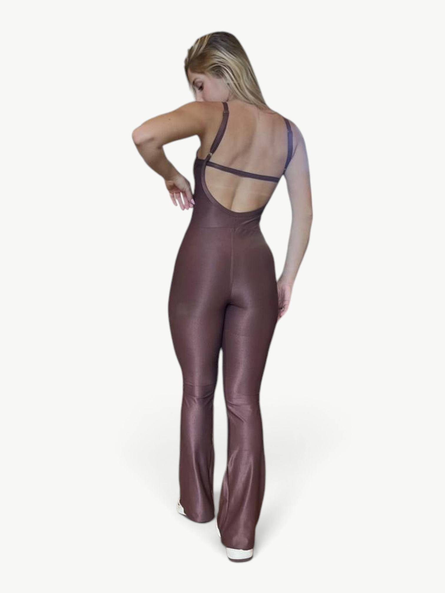 Woman wearing a brown JM Brazilian Activewear flare jumpsuit with a backless design and thin straps
