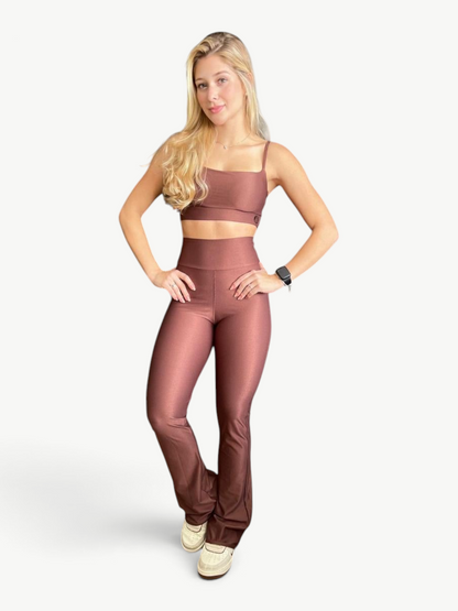 Model wearing a JM Brazilian Activewear brown two-piece set with a fitted crop top and high-waisted flare pants.