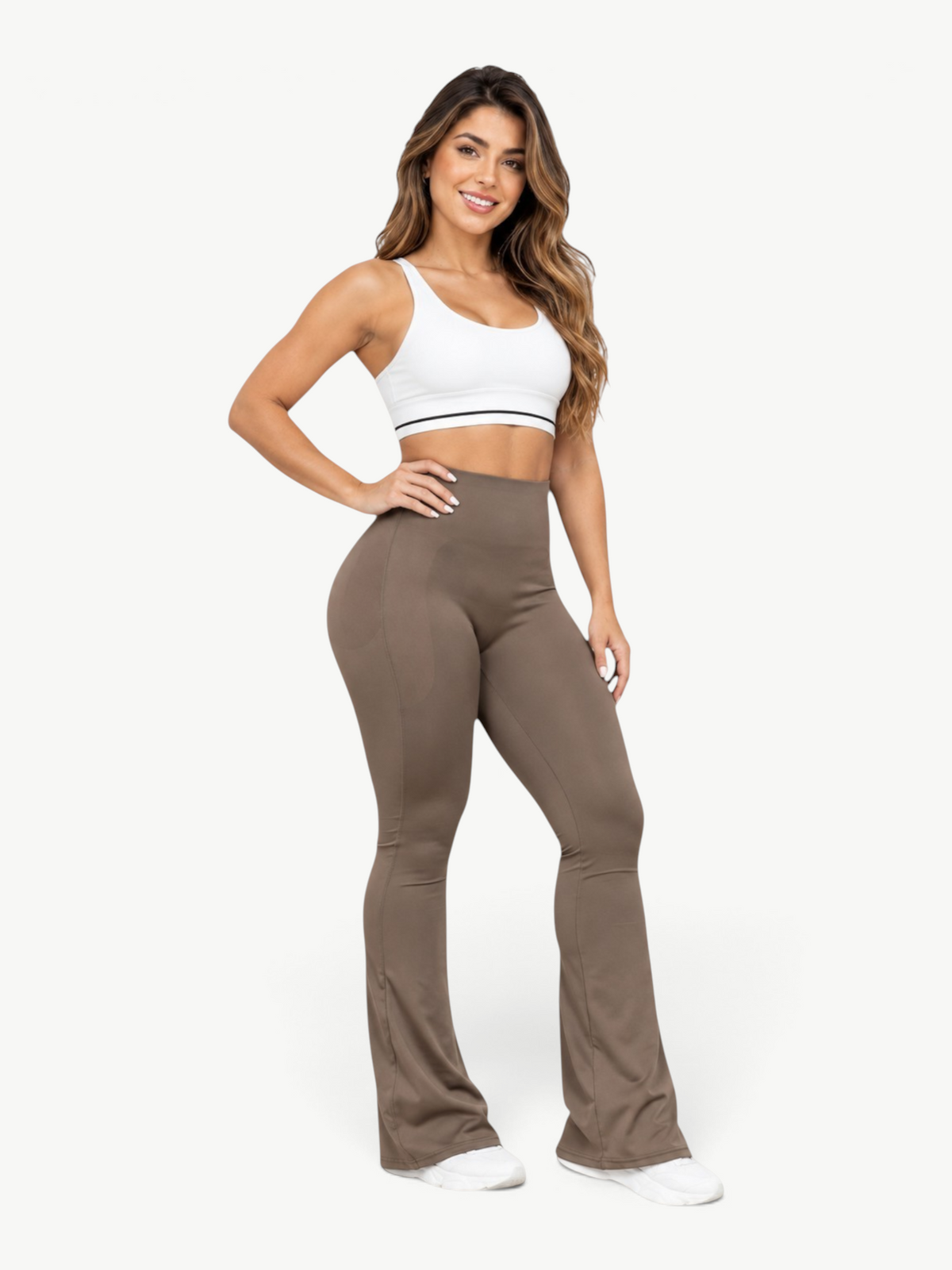 JM Brazilian Activewear sculpting leggings in brown with a flared leg design worn by a smiling woman in a white top