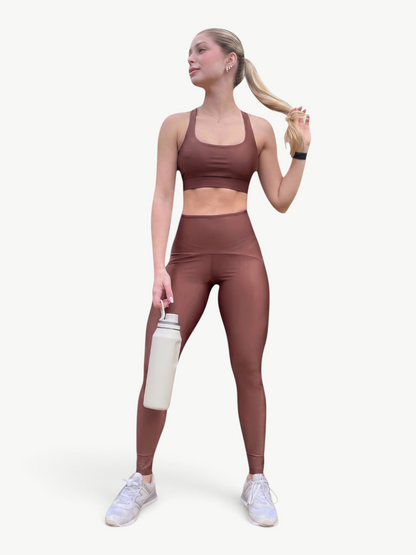 Model wearing a brown JM Brazilian Activewear Sunny Legging Set with a strappy-back top and high-waisted leggings.