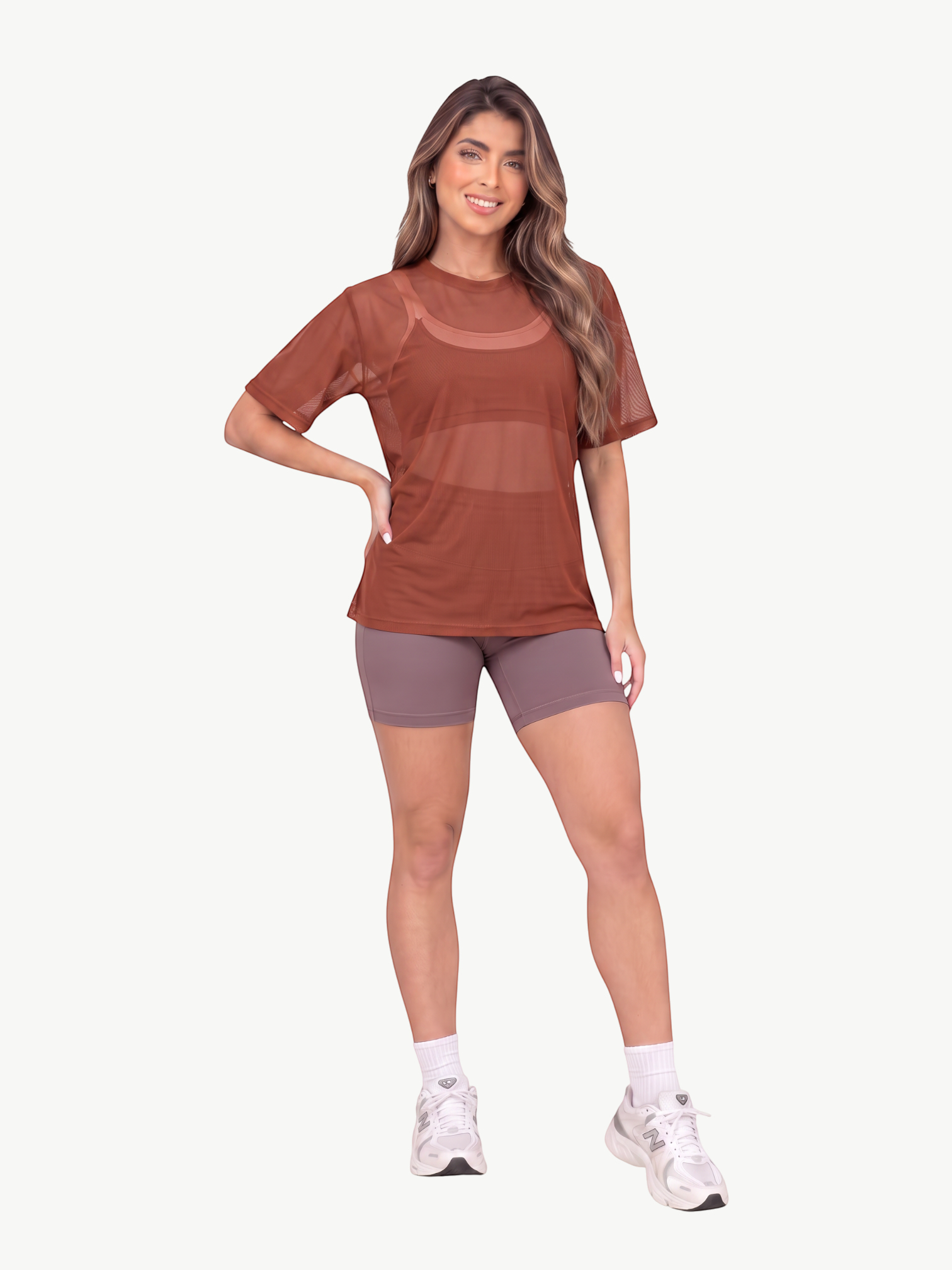Model wearing a JM Brazilian Activewear brown sheer mesh t-shirt over a sports bra with matching athletic shorts.