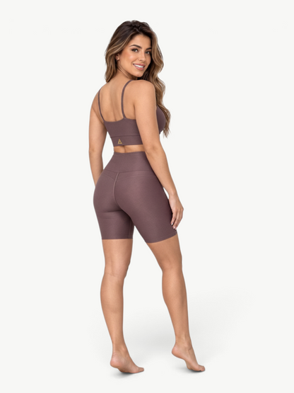 Model wearing JM Brazilian Activewear brown ribbed two-piece set with crop top and high-waisted biker shorts