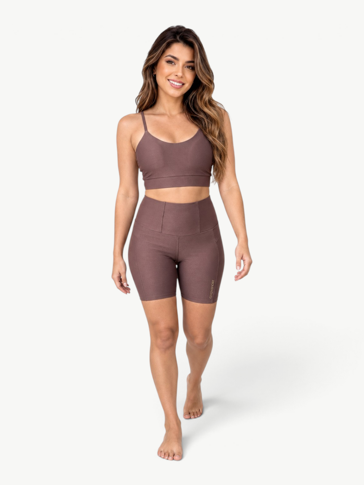 Model wearing a JM Brazilian Activewear brown ribbed two-piece set with a scoop-neck crop top and high-waisted shorts.