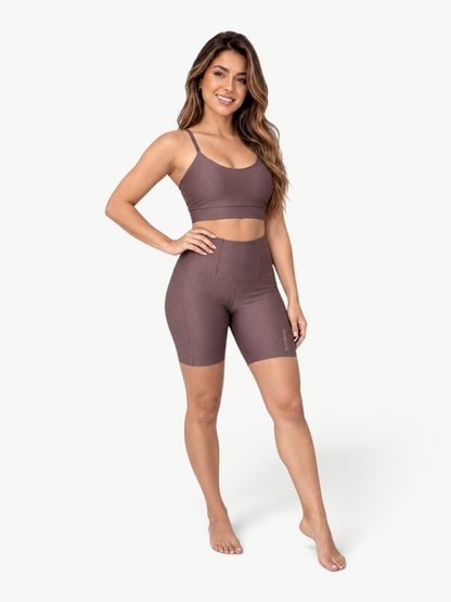 Model wearing a brown JM Brazilian Activewear ribbed two-piece set with a scoop-neck crop top and high-waisted shorts.