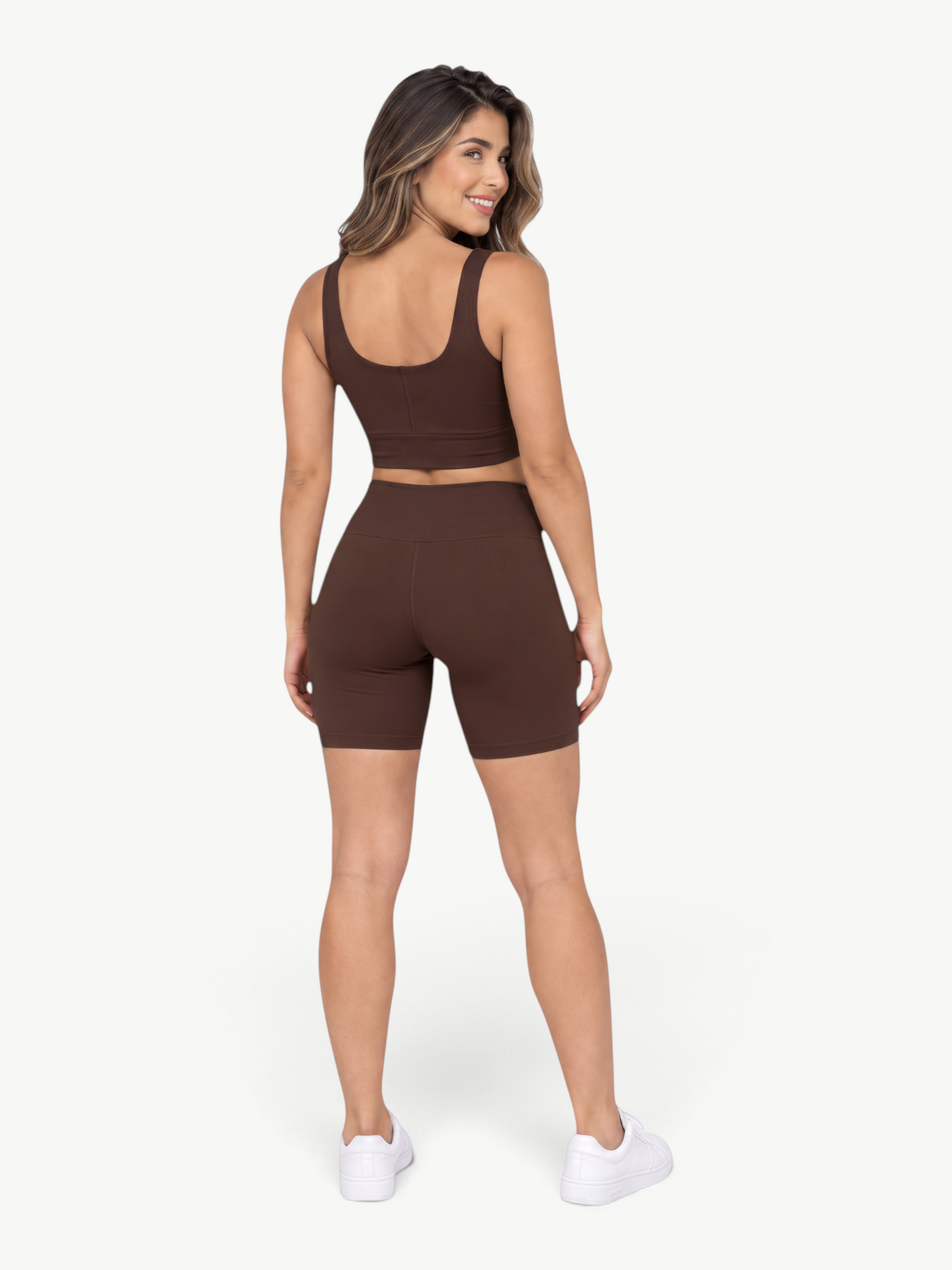 Model wearing JM Brazilian Activewear brown Sculpt Biker Short Set with cropped tank and high-waisted shorts, back view