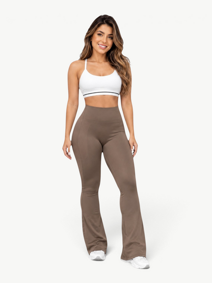 Model wearing JM Brazilian Activewear brown sculpting leggings with a white sports bra for a flattering fit.