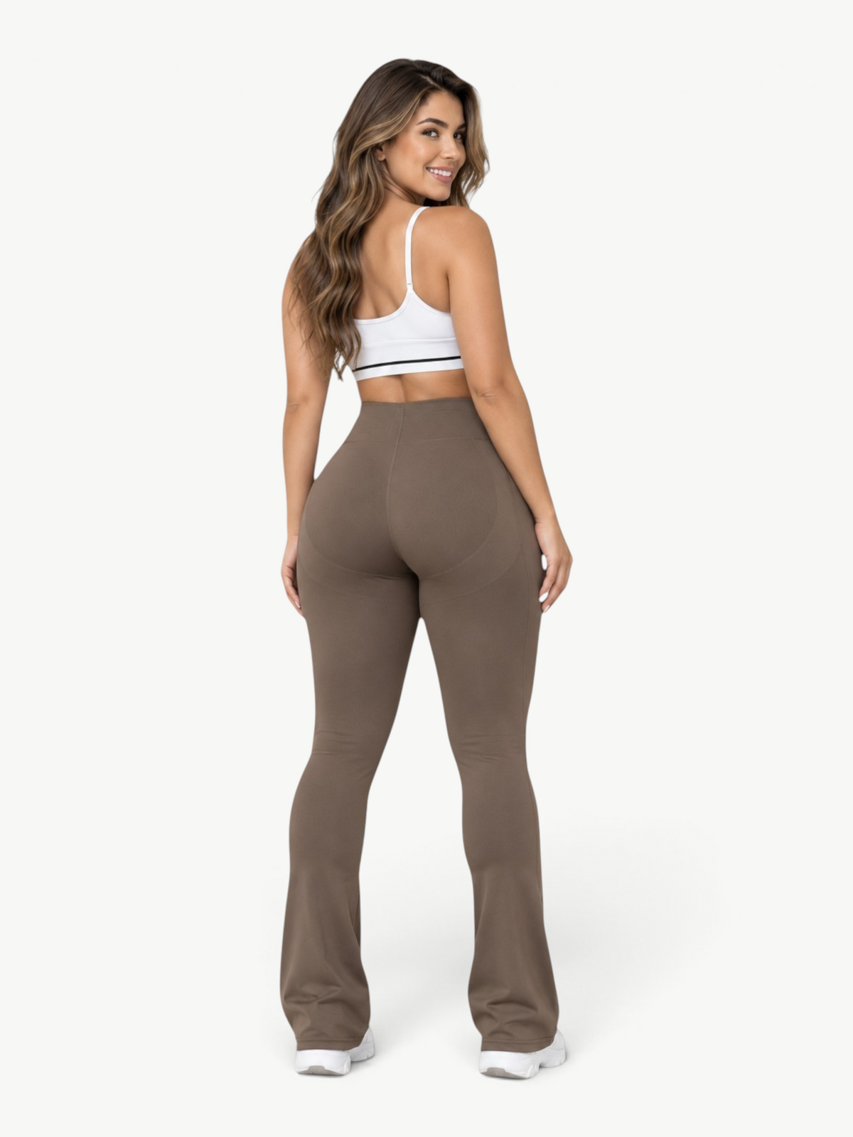 Woman wearing JM Brazilian Activewear brown sculpting leggings with a flared leg design and high-stretch fabric