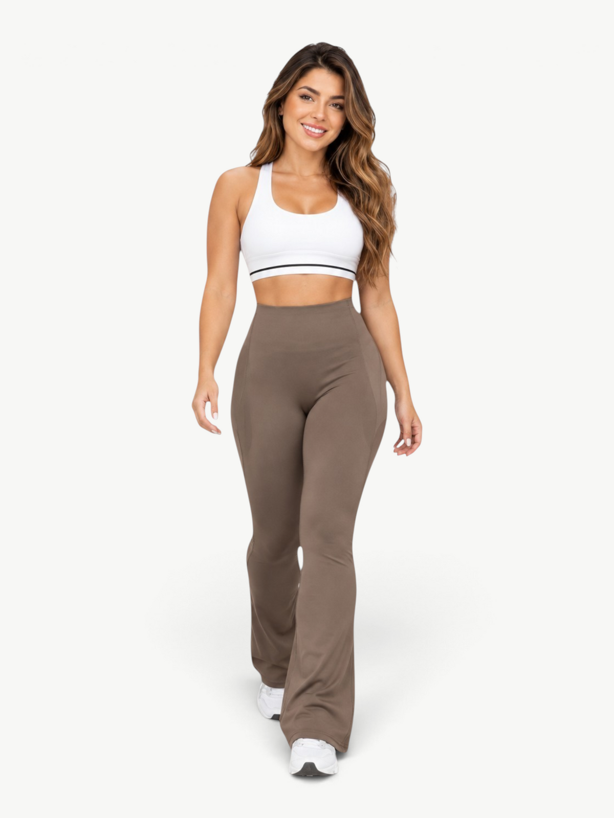 Model wearing JM Brazilian Activewear brown high-waisted sculpting leggings and a white sports bra