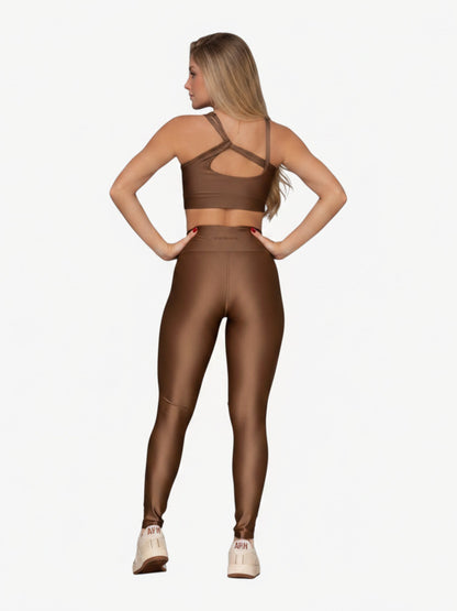 JM Brazilian Activewear brown sculpting two-piece set with a crossback top and high-waisted leggings on a model