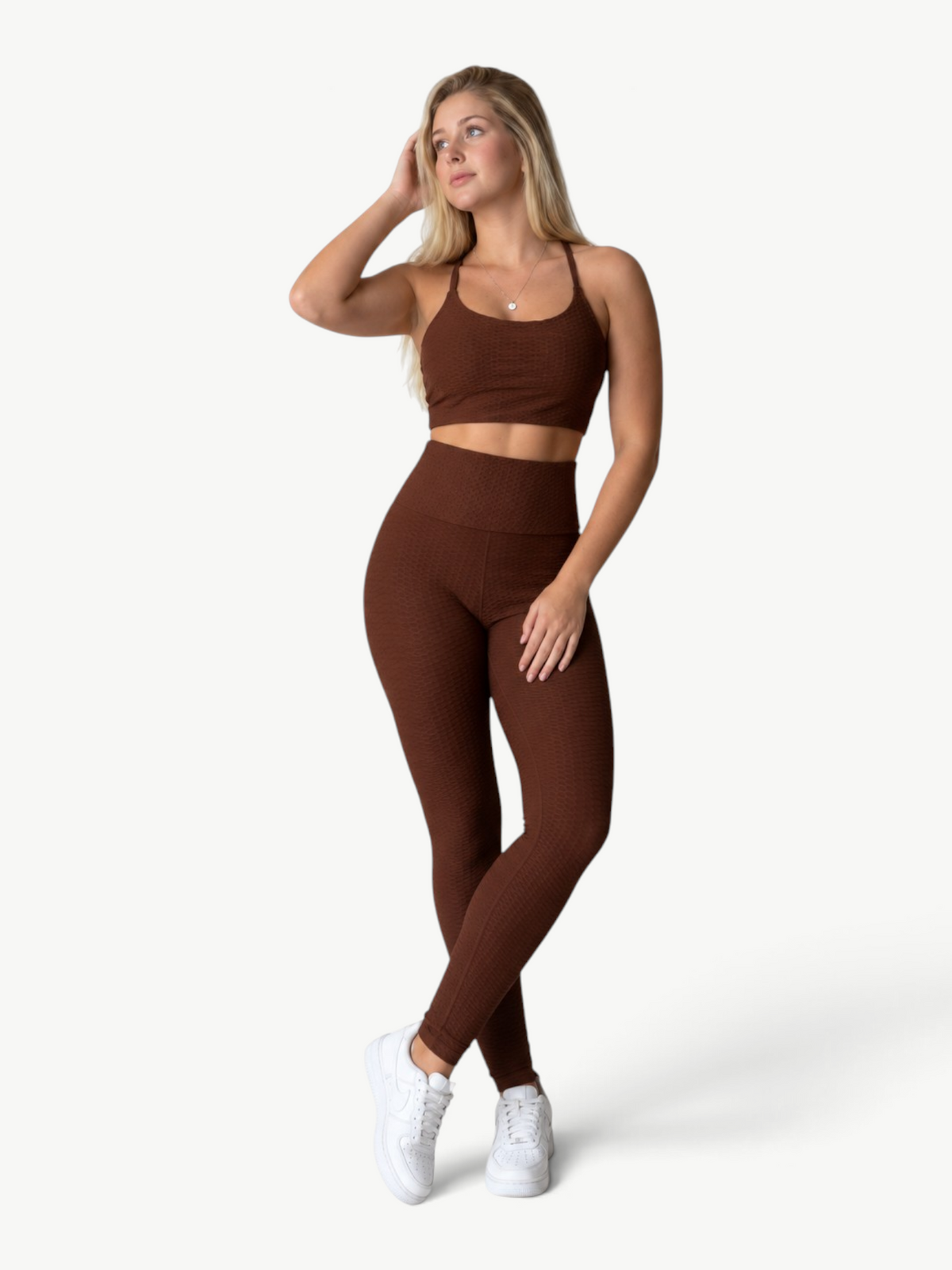Model wearing a brown JM Brazilian Activewear textured crop top and high-waisted leggings set for workouts