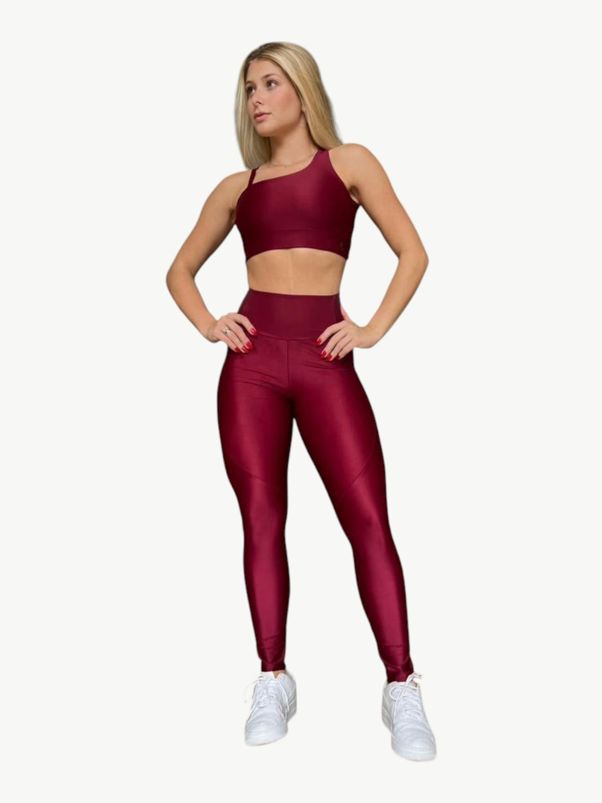 Model wearing a JM Brazilian Activewear burgundy sculpting crossback top and high-waisted leggings set
