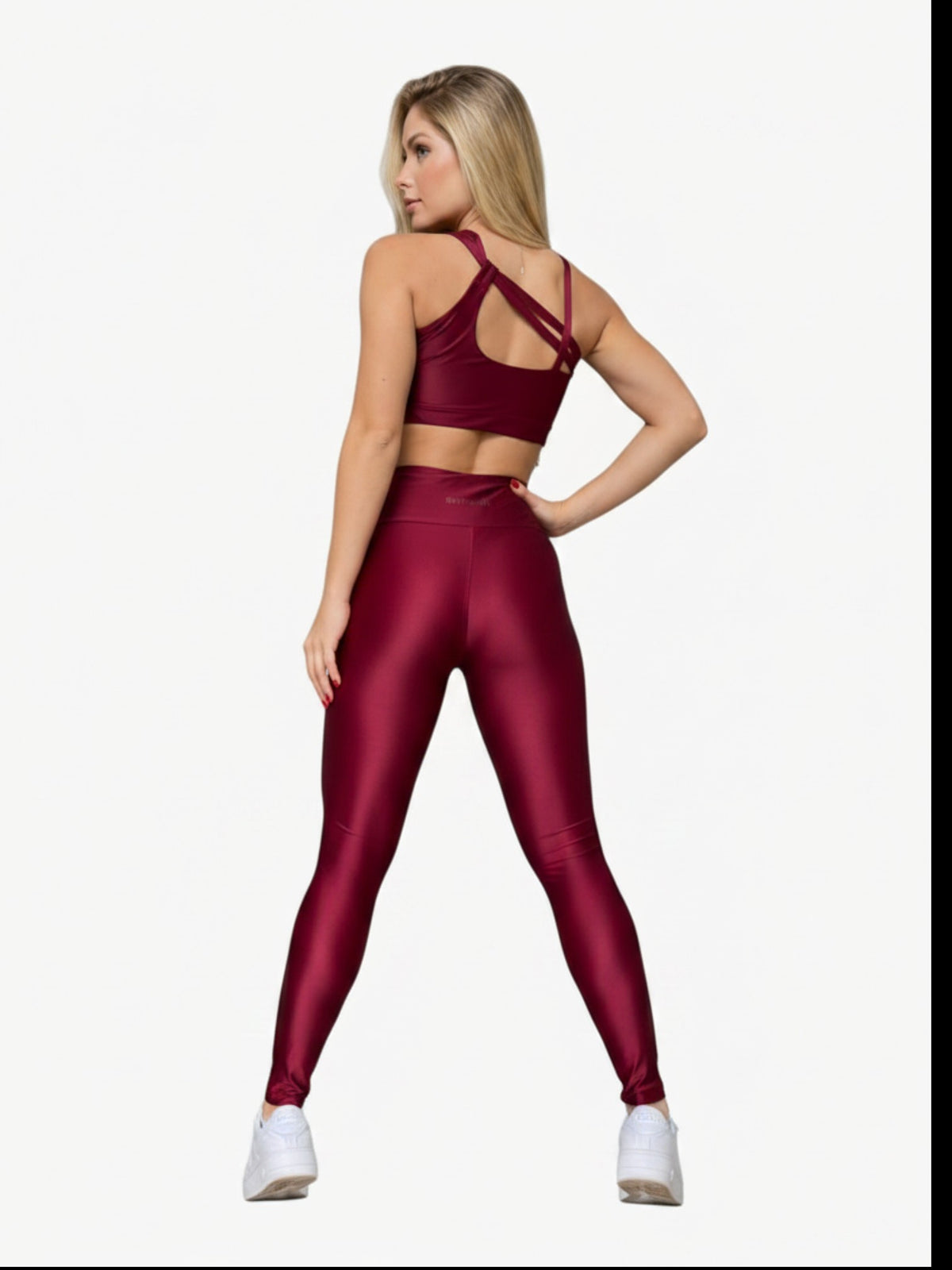 Model wearing JM Brazilian Activewear burgundy crossback sculpting set with high-waisted leggings, back view.