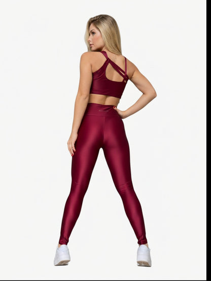 Model wearing JM Brazilian Activewear burgundy crossback sculpting set with high-waisted leggings, back view.