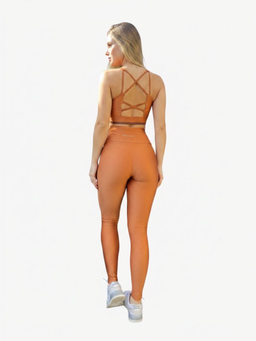 JM Brazilian Activewear copper cross-back sports bra and high-waisted leggings set worn by a woman from behind