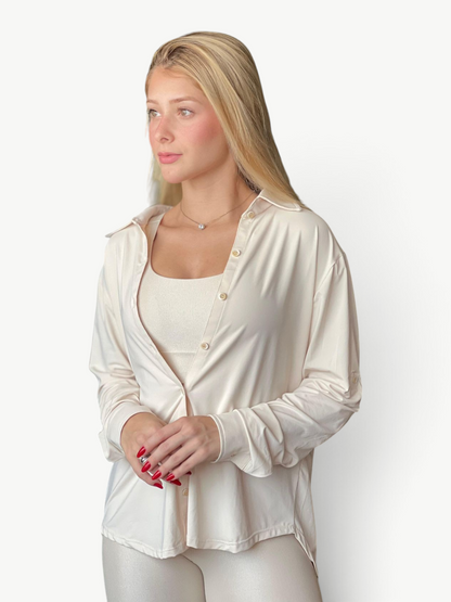 JM Brazilian Activewear long sleeve button-up top in cream, worn over a matching tank top for a versatile layered look.