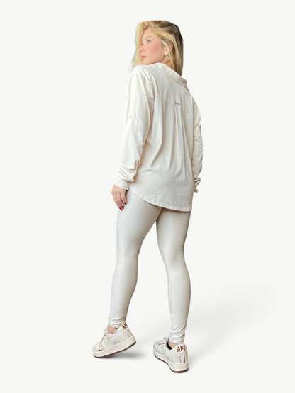 Model wearing JM Brazilian Activewear long sleeve cream button-up top and matching leggings, back view