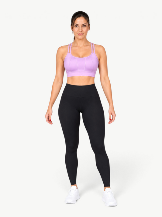 Model wearing JM Brazilian Activewear lavender Angel Strappy Back Top with black high-waisted leggings