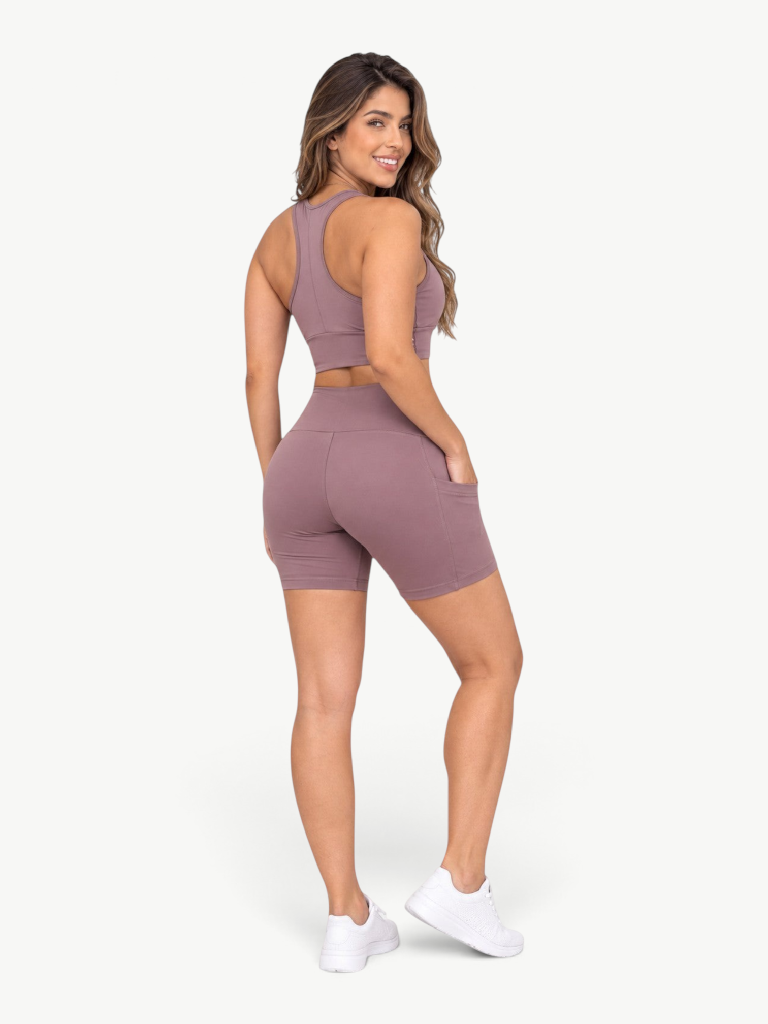 JM Brazilian Activewear mauve high-waisted biker shorts with side pockets worn by a woman, back view.