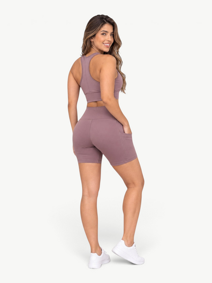 JM Brazilian Activewear mauve high-waisted biker shorts with side pockets worn by a woman, back view.