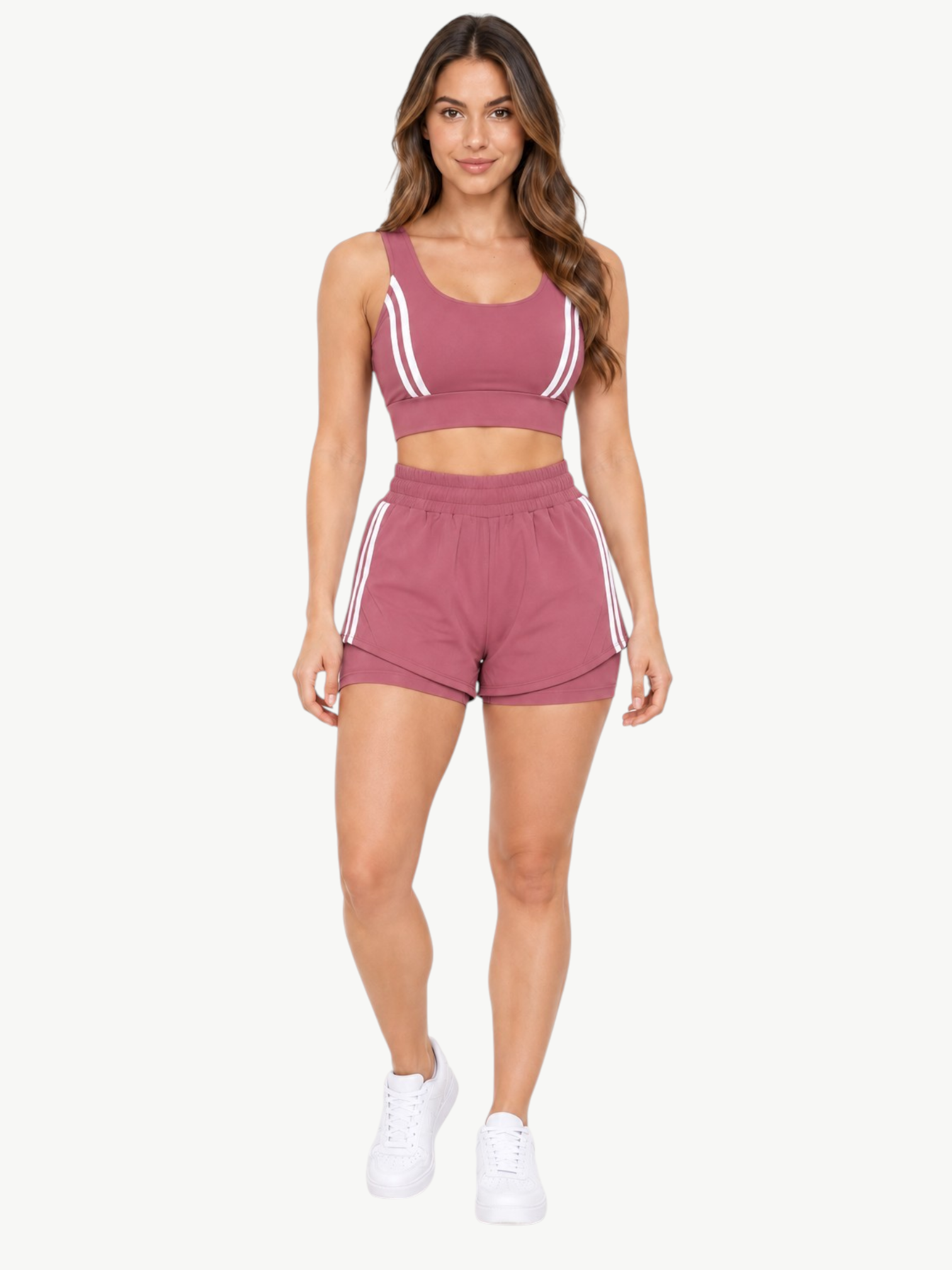 Model wearing a mauve JM Brazilian Activewear 2-in-1 short set with a supportive crop top and layered athletic shorts.