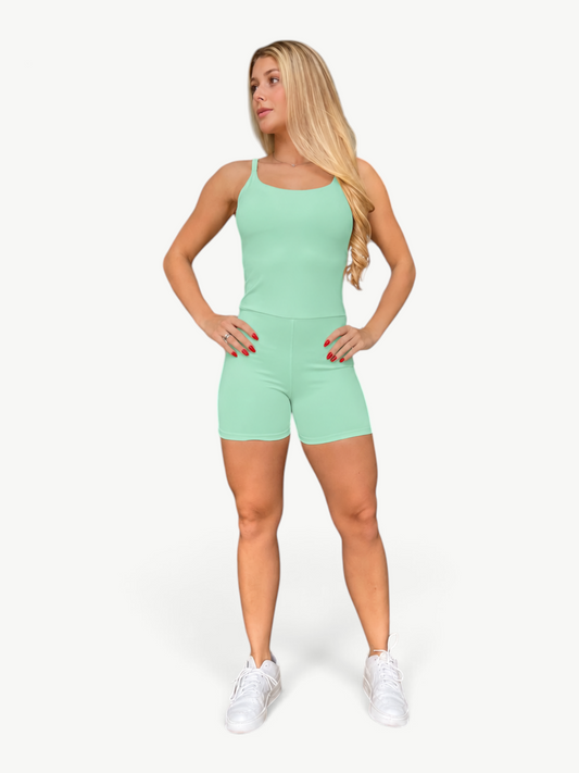 Woman wearing a mint green JM Brazilian Activewear Sculpt Romper with a fitted silhouette and spaghetti straps.